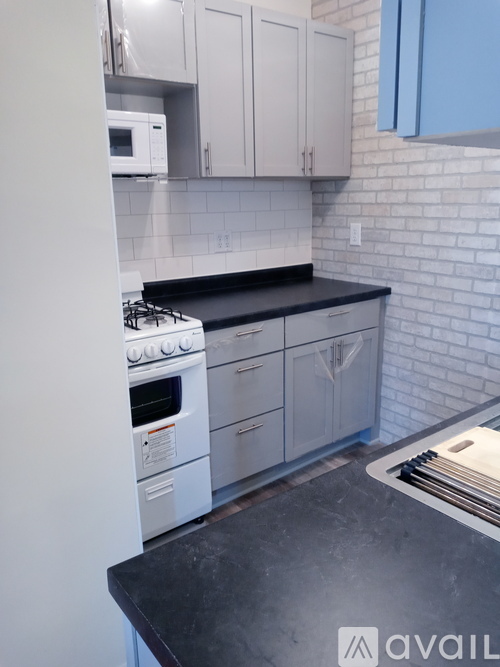 A kitchen with a white oven and black countertop.