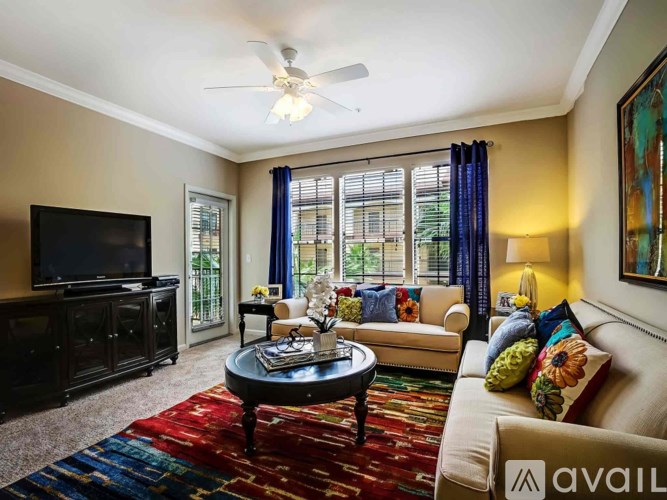 A living room with a television, a sofa, and a coffee table.