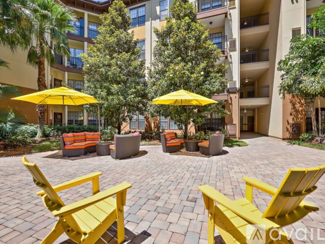 A yellow chair is in front of a building.