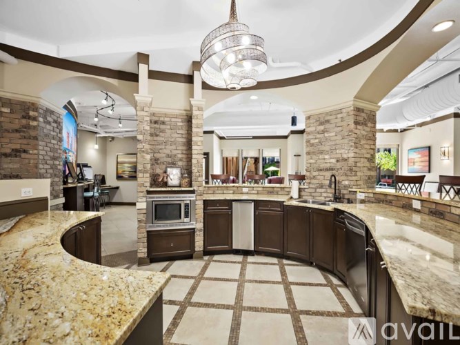 A modern kitchen with a central island and a stone backsplash.