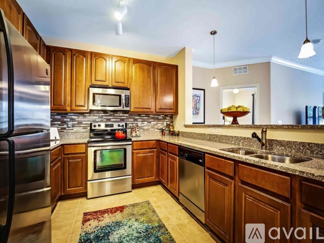 A kitchen with wooden cabinets and stainless steel appliances.