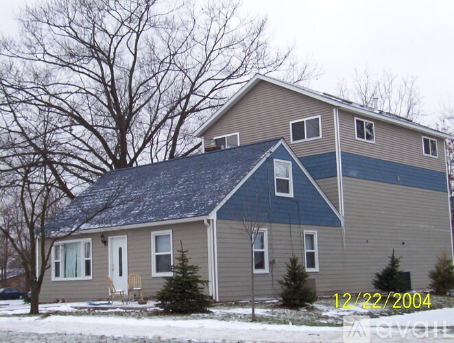 A house with a blue roof and a white door.