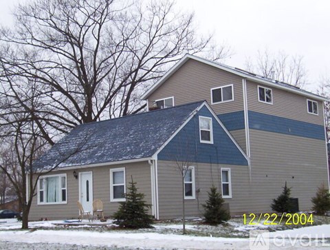 A house with a blue roof and a white door.
