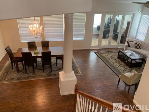 A living room with a dining table and chairs.