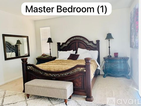 A bedroom with a large bed and a bench in front of it.