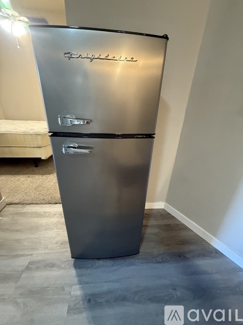 A Philco fridge is in a room with a white wall and a rug.