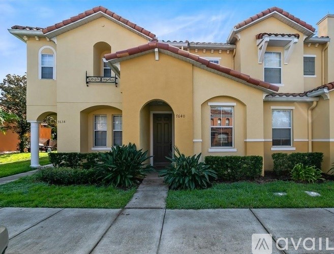 A two-story house with a balcony on the second floor.