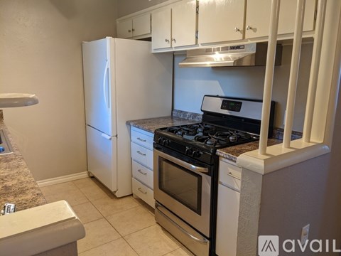 A kitchen with a stove, oven, and refrigerator.
