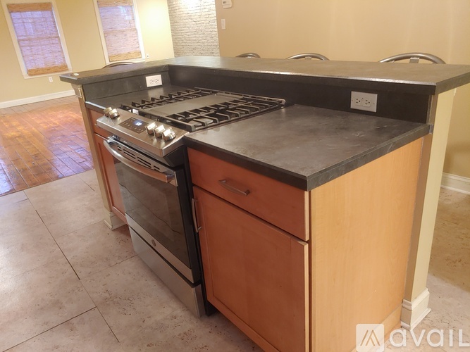 A kitchen with a stove top oven and a double oven below it.