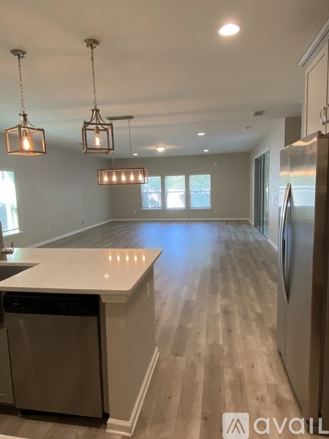 A kitchen with a white countertop and a dishwasher.