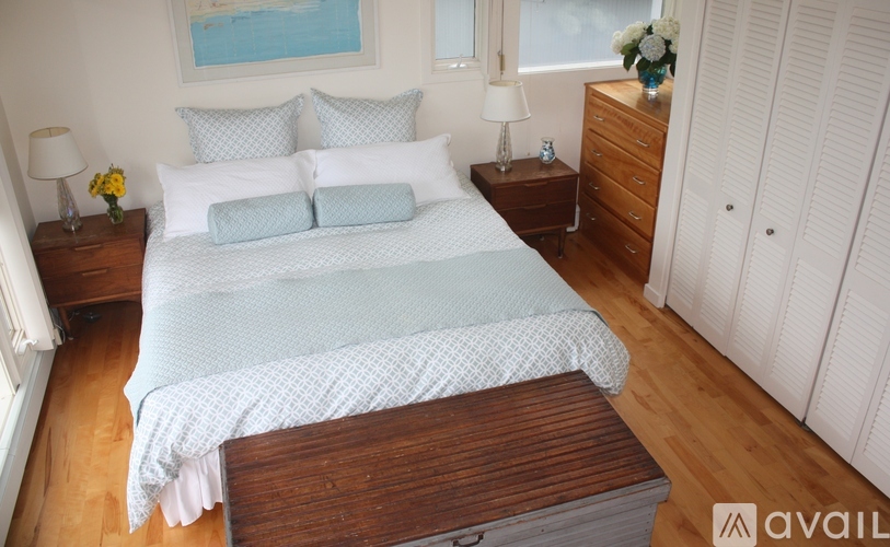 A bedroom with a large bed and a wooden coffee table.