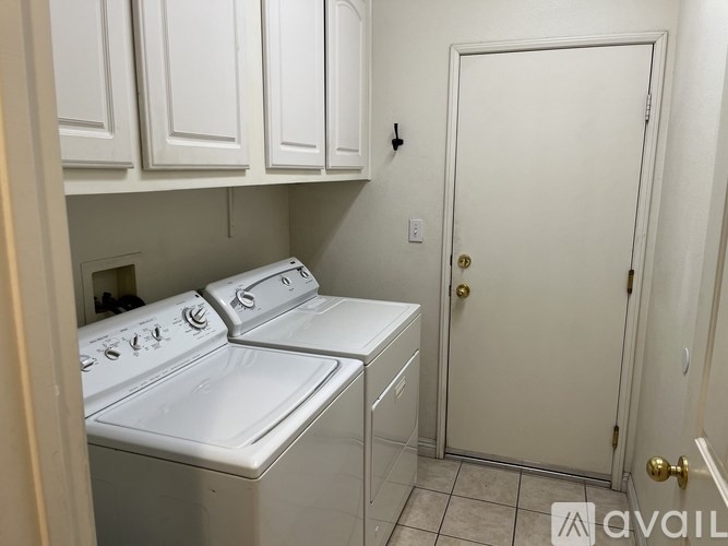 A small laundry room with a washer and dryer.