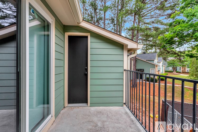 A small house with a black door and a glass window.