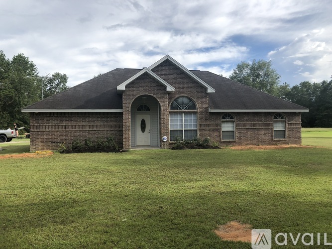 A house with a grey door and windows is for sale.