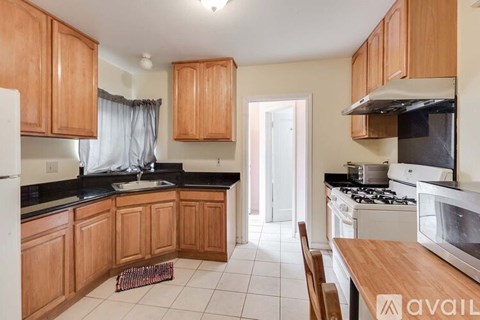 A kitchen with wooden cabinets and a white refrigerator.