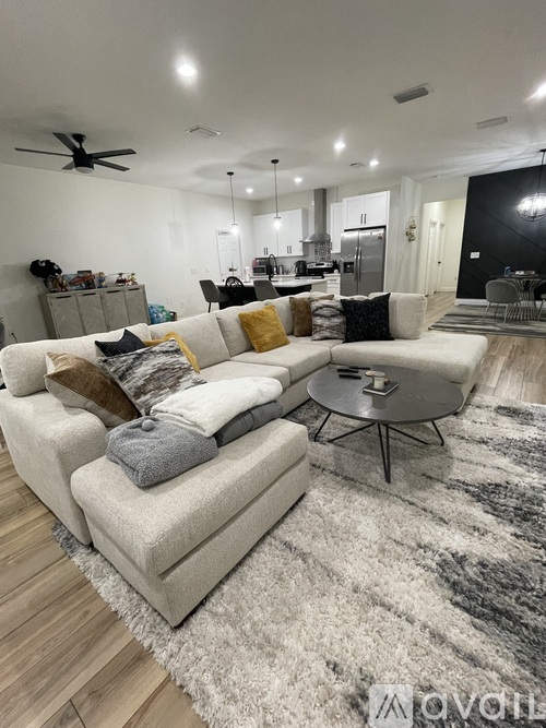 A modern living room with a white couch and a round coffee table.