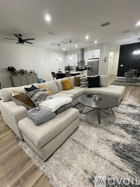A modern living room with a white couch and a round coffee table.