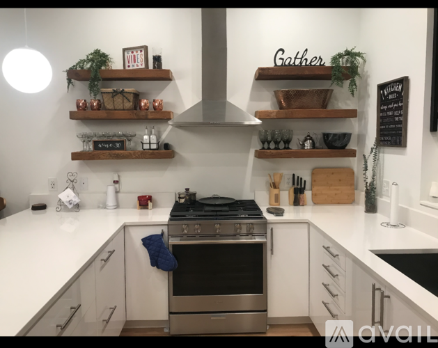 A kitchen with a stove top oven and a sign that says Gather.
