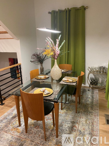 A dining room with a glass table and chairs.