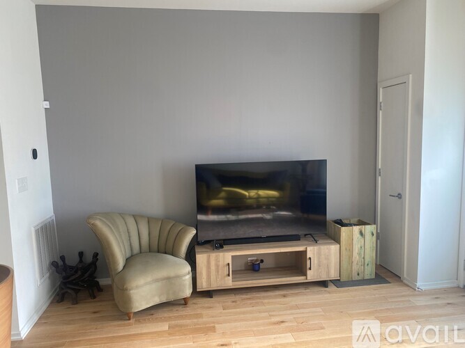 A living room with a television and a chair.