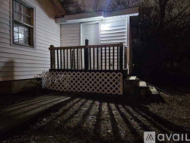 A house with a white door and a wooden porch.