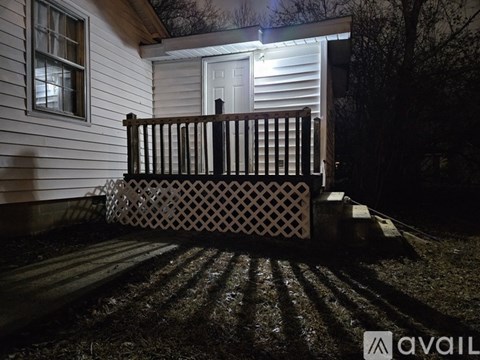 A house with a white door and a wooden porch.