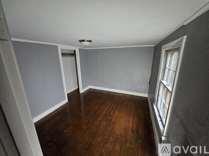 A room with wooden floors and a window.