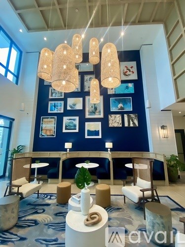 A living room with a blue wall and a white ceiling.
