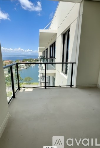 A balcony with a view of the water and sky.