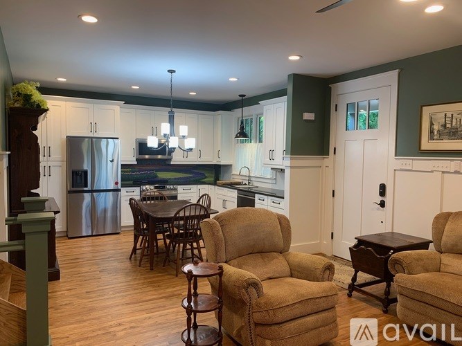 A living room with a dining table and chairs.