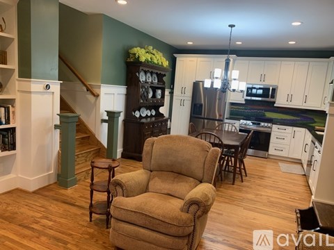 A living room with a chair and a cabinet.