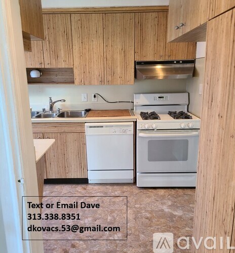 A kitchen with wooden cabinets and white appliances.