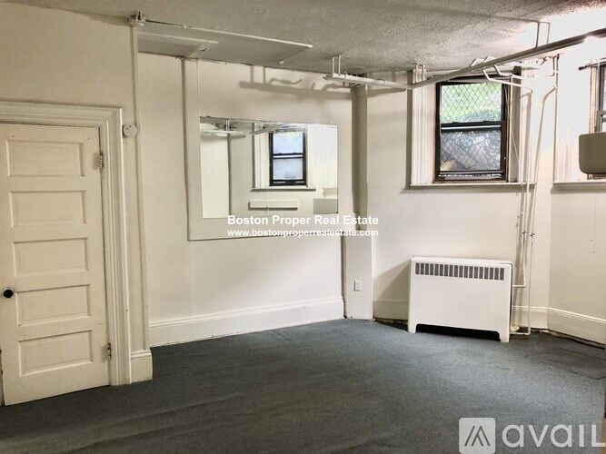 A room with a door, window, and a radiator.