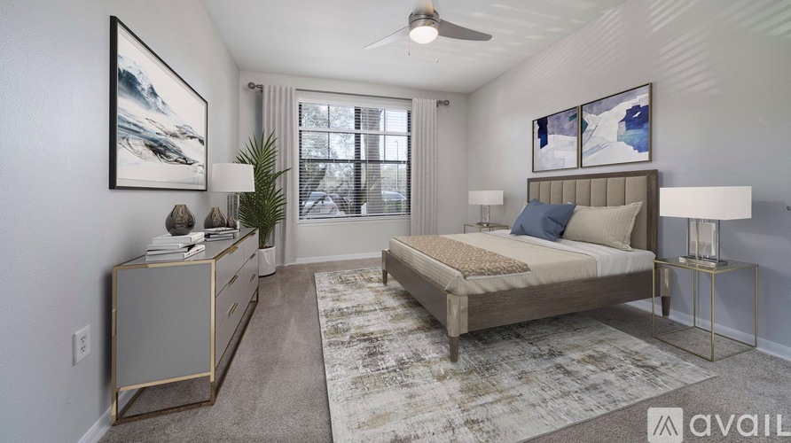 A bedroom with a bed, nightstand, and a rug.
