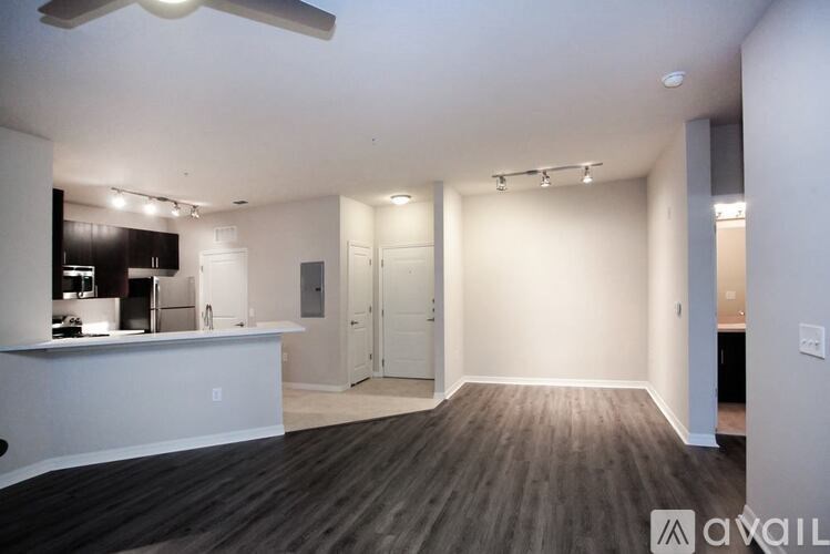 A spacious room with a kitchen area and a bar.