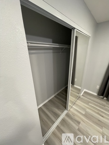 A room with a sliding door and wooden flooring.