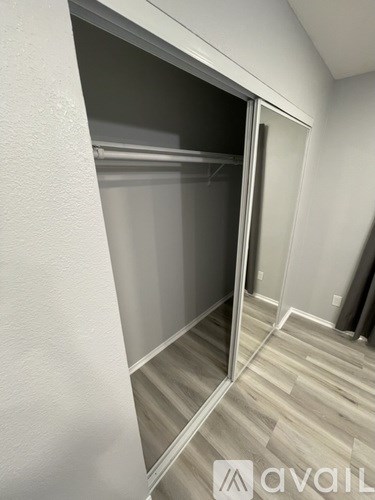 A room with a sliding door and wooden flooring.