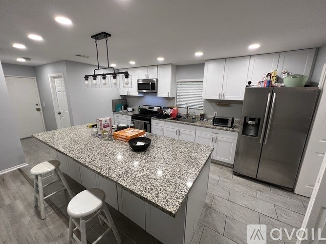 A kitchen with granite countertops and stainless steel appliances.