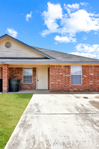 A house with a white door and windows is shown.