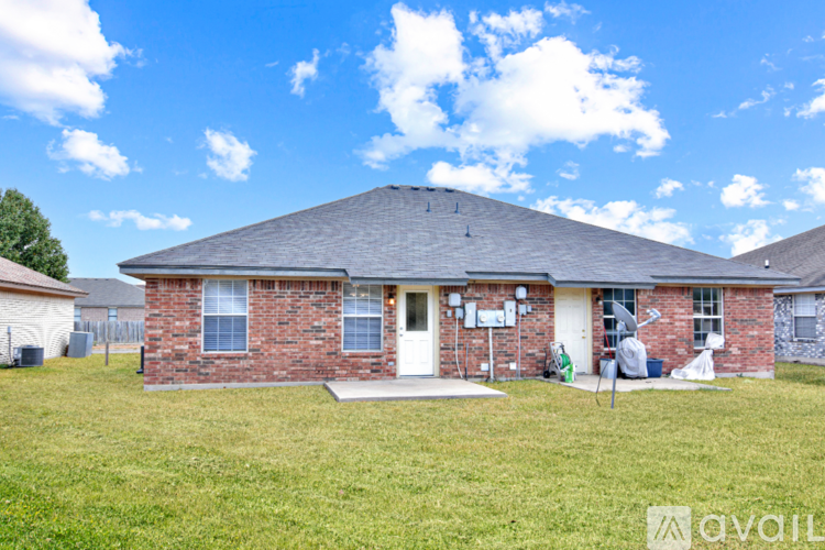 A house with a brick exterior and a white door is for sale.