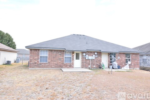 A house with a brick exterior and a white door is for sale.