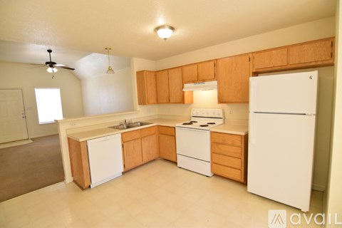 A kitchen with wooden cabinets and white appliances.