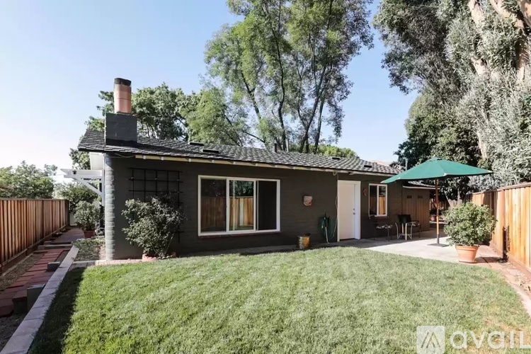 A house with a green lawn and a fence.