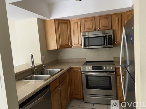 A kitchen with wooden cabinets and stainless steel appliances.