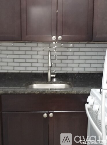 A kitchen with brown cabinets and a white oven.