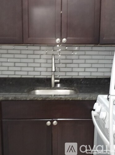 A kitchen with brown cabinets and a white oven.