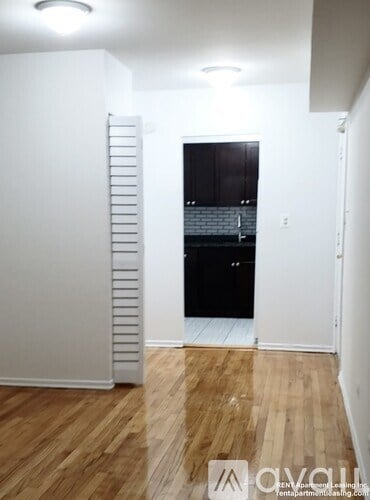A room with wooden floors and a white door.