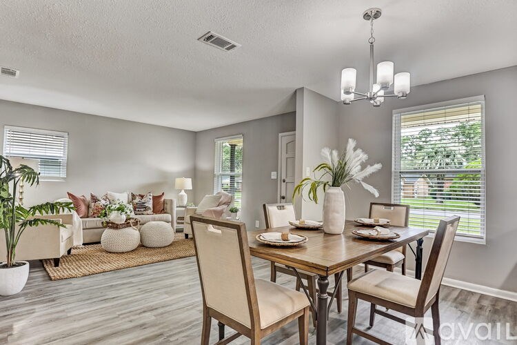 A dining room with a wooden table set for two.