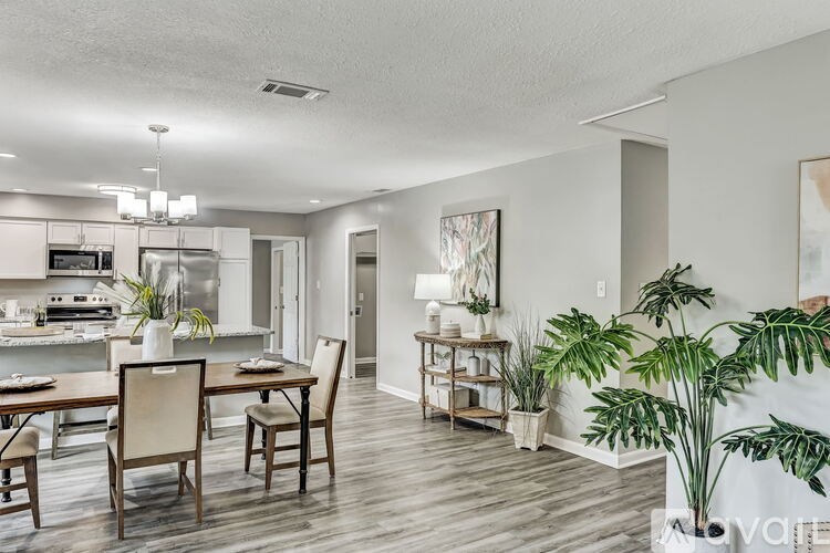 A dining room with a wooden table and chairs.