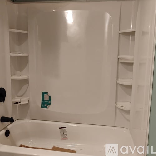 A white refrigerator with a brown paper towel on the bottom shelf.